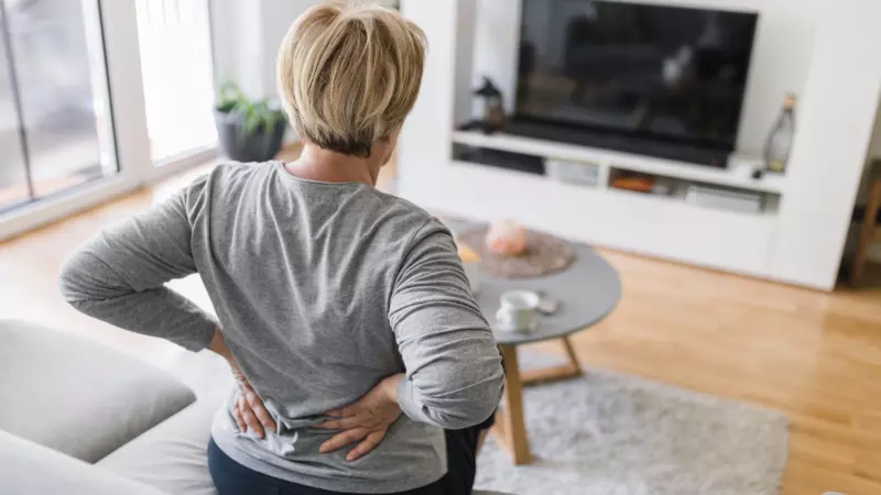 Women holding her back due to back pain. 